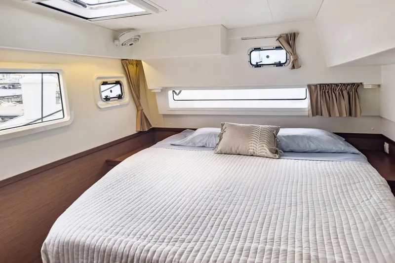 Slide: The Image of Luxurious cabin interior of 2020 Lagoon 42 catamaran with cozy bed and windows. - 46