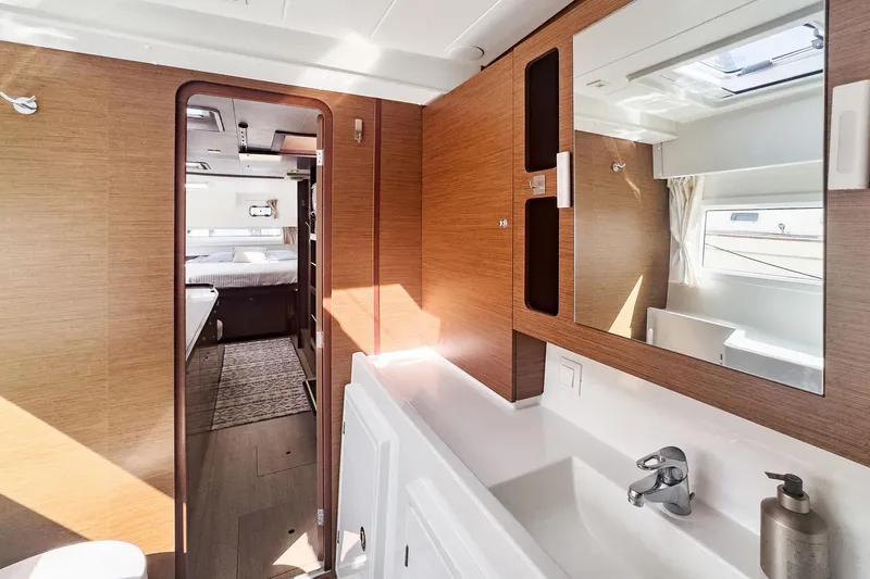 Slide: The Image of Interior of 2020 Lagoon 42 yacht featuring modern bathroom and bedroom. - 52