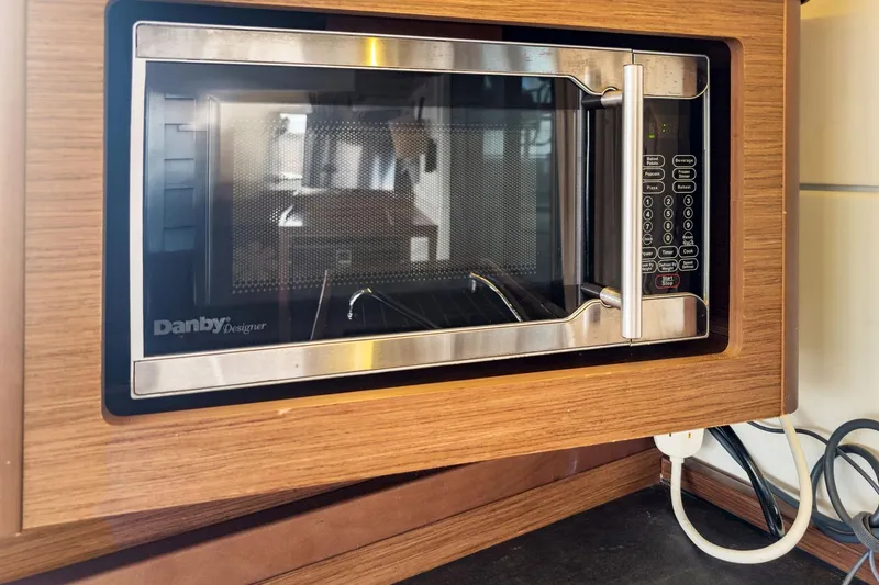 Slide: The Image of Built-in Danby Designer microwave in Lagoon 42, 2020 model, wooden cabinetry. - 27