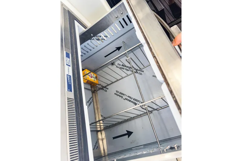 Slide: The Image of Open refrigerator on Lagoon 42 yacht, 2020 model, with a single item inside. - 77