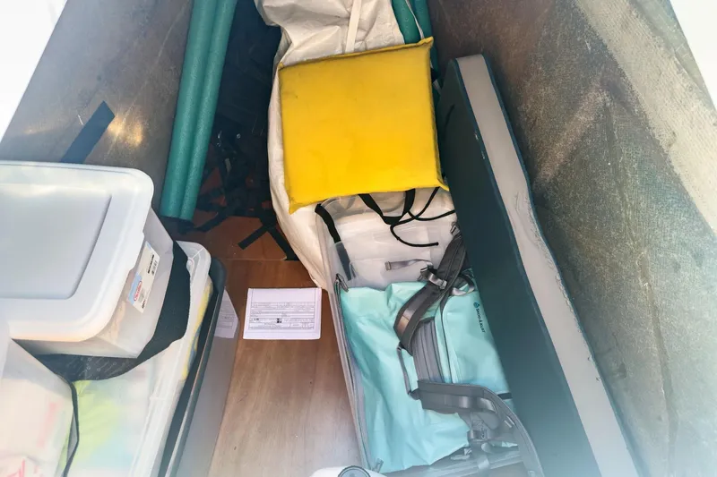 Slide: The Image of Storage compartment of a 2020 Lagoon 42 yacht with various items and equipment. - 81