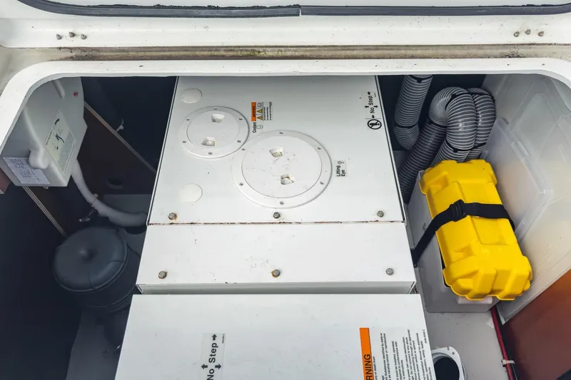 Slide: The Image of Engine compartment of a 2020 Lagoon 42 catamaran with equipment and safety gear. - 69