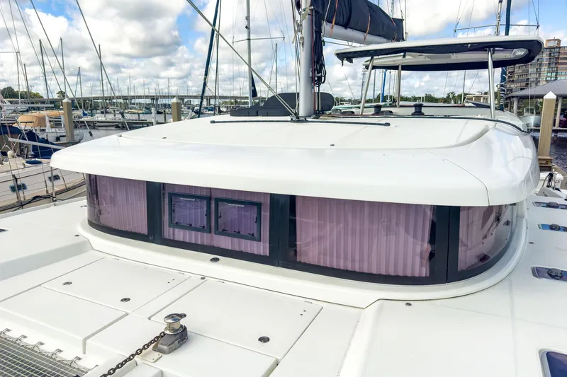 Slide: The Image of 2020 Lagoon 42 catamaran docked at marina, showcasing sleek design and modern features. - 14