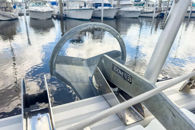 Slide: The Image of Anchor on Lagoon 42 catamaran, 2020 model, docked at marina with boats. - 17