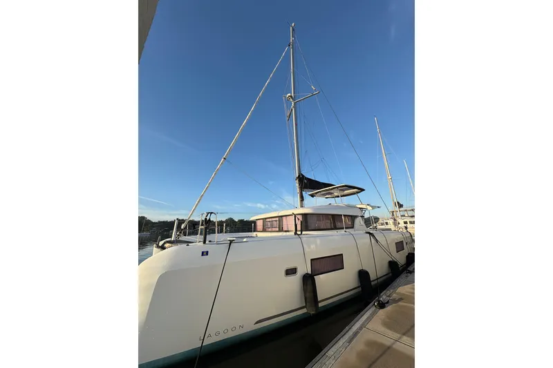 Slide: The Image of 2020 Lagoon 42 catamaran docked under clear blue sky. - 93