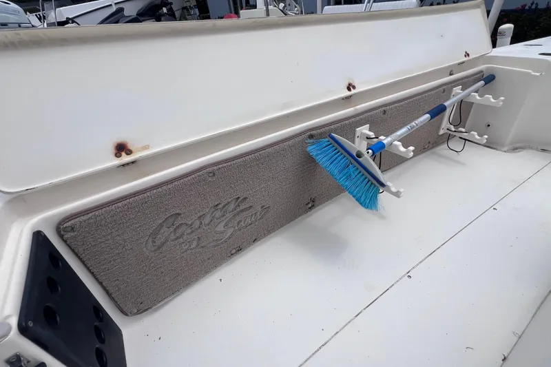 Slide: The Image of 2007 Scout 170 Costa boat interior with mounted blue brush and storage rack. - 12