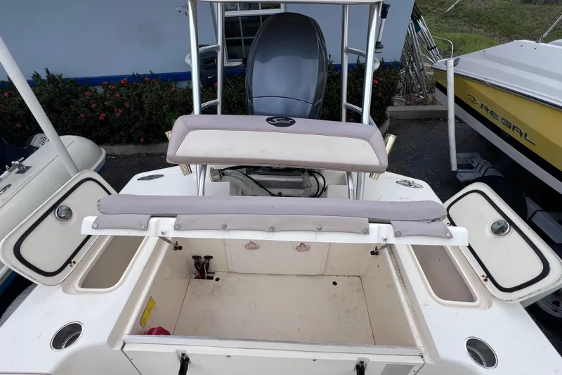 Slide: The Image of 2007 Scout 170 Costa boat interior with open storage compartments and seating. - 13