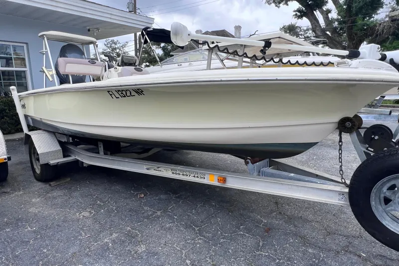 Slide: The Image of 2007 Scout 170 Costa boat on trailer, parked outdoors near a building. - 2