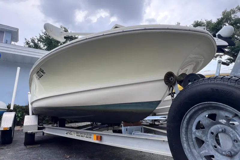 Slide: The Image of 2007 Scout 170 Costa boat on trailer, parked outdoors under cloudy sky. - 3