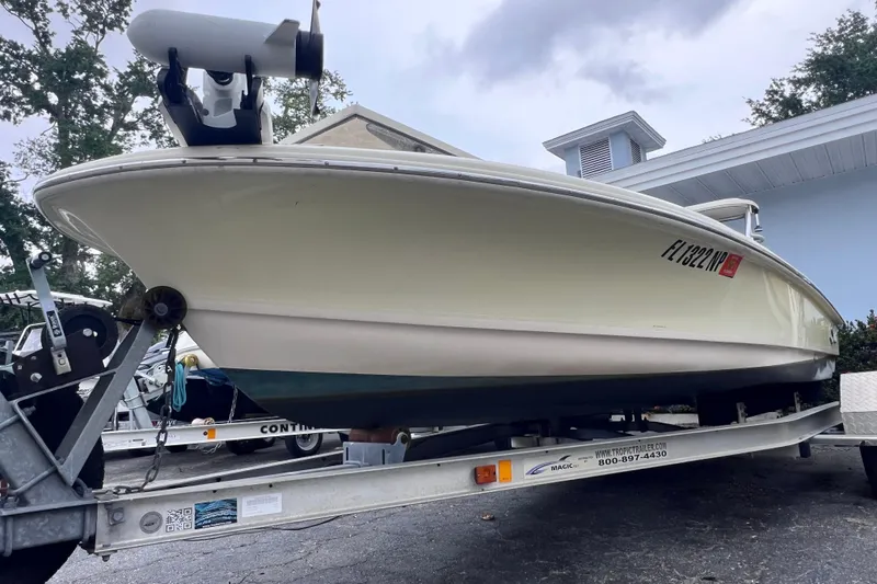 Slide: The Image of 2007 Scout 170 Costa boat on trailer, parked outdoors near a building. - 4