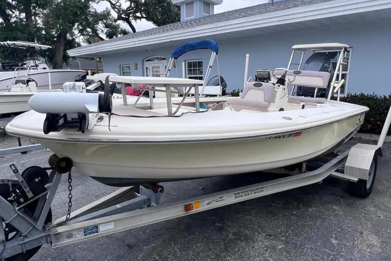 Slide: The Image of 2007 Scout 170 Costa boat on trailer, parked near a light blue building. - 5