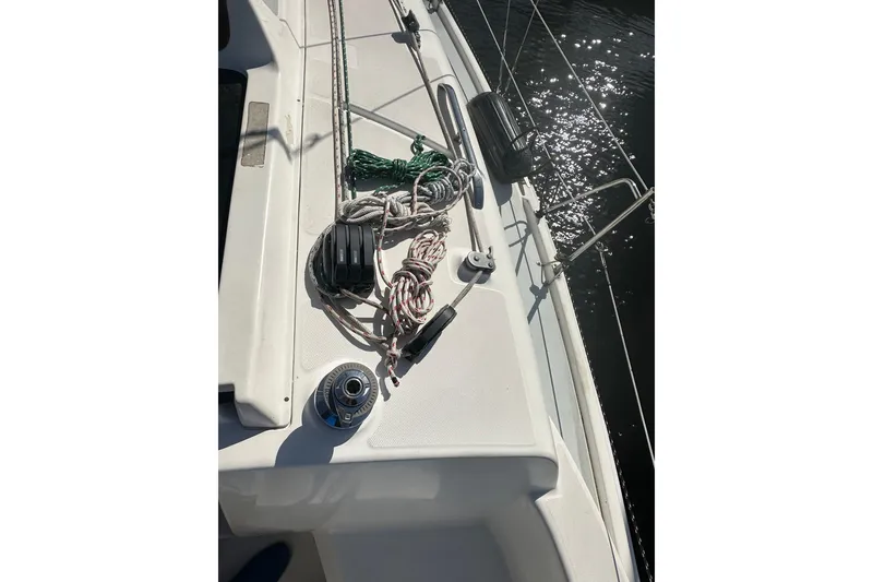 Slide: The Image of Deck of 2002 Hunter 306 sailboat with ropes and winch in sunlight. - 12