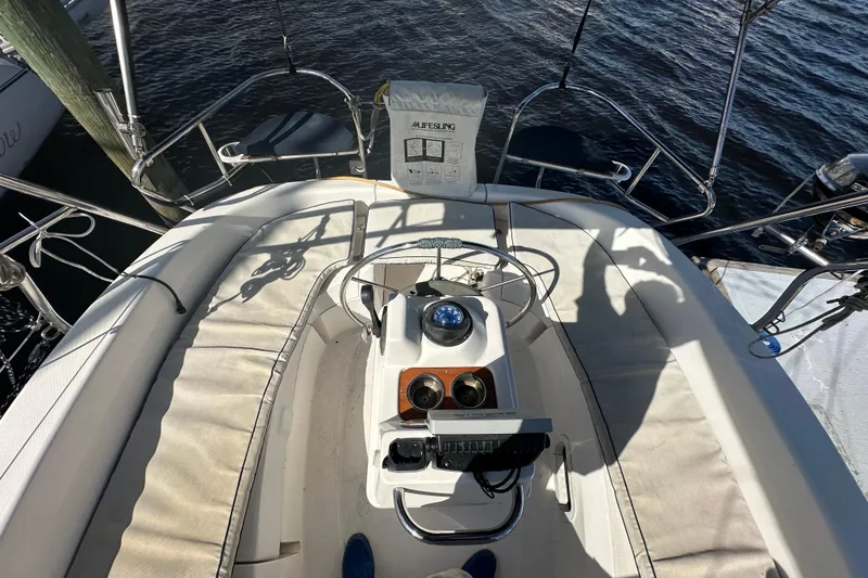 Slide: The Image of Cockpit view of a 2002 Hunter 306 sailboat with steering wheel and navigation instruments. - 13