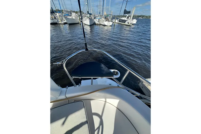 Slide: The Image of Bow view of a 2002 Hunter 306 sailboat docked in a marina. - 14