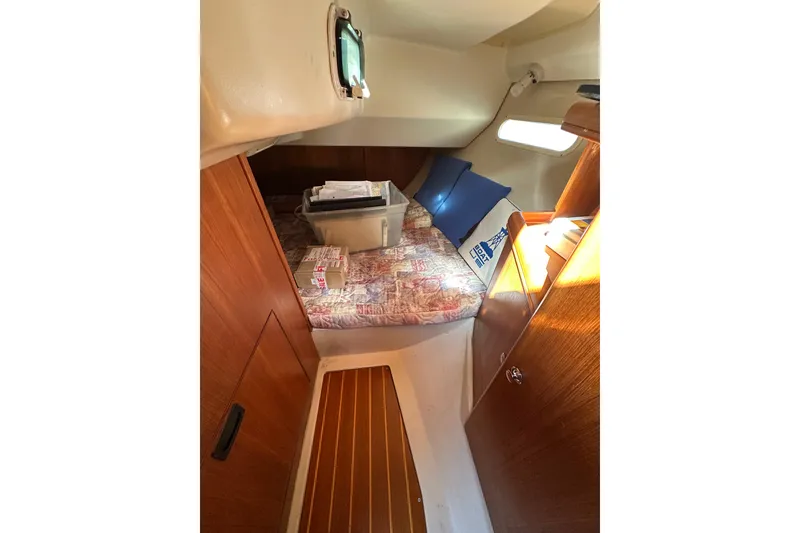 Slide: The Image of Cozy cabin interior of 2002 Hunter 306 sailboat with bed and storage. - 18