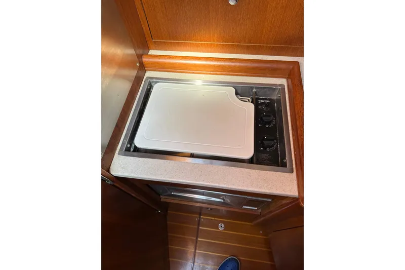 Slide: The Image of Built-in stove with cover in 2002 Hunter 306 yacht kitchen. - 21