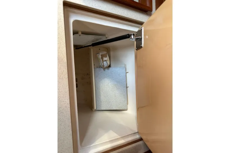 Slide: The Image of Open storage compartment in a 2002 Hunter 306 boat interior. - 24