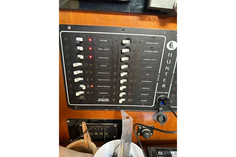 Slide: The Image of Electrical control panel on a 2002 Hunter 306 sailboat, featuring various switches and indicators. - 27