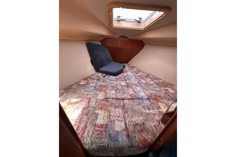 Slide: The Image of Cozy cabin interior of 2002 Hunter 306 sailboat with patterned bedding and overhead hatch. - 31