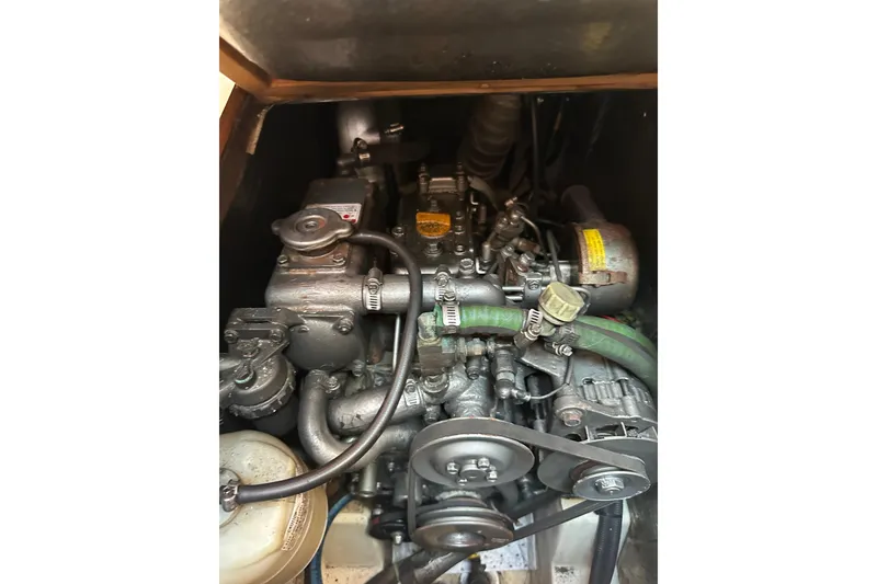 Slide: The Image of Engine compartment of a 2002 Hunter 306 sailboat, showcasing mechanical components. - 35