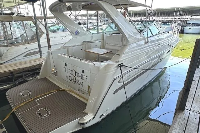 The Image of 2001 Maxum 3000 SCR yacht docked in marina, featuring spacious deck and sleek design. - 0