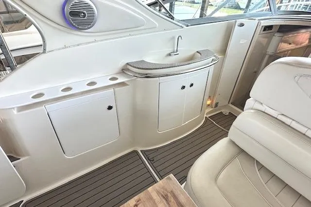 Slide: The Image of 2001 Maxum 3000 SCR yacht interior with sink, seating, and storage cabinets. - 10