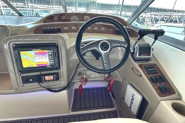 Slide: The Image of 2001 Maxum 3000 SCR boat dashboard with steering wheel and navigation system. - 12