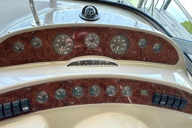 Slide: The Image of Dashboard of 2001 Maxum 3000 SCR boat with wood paneling and gauges. - 14