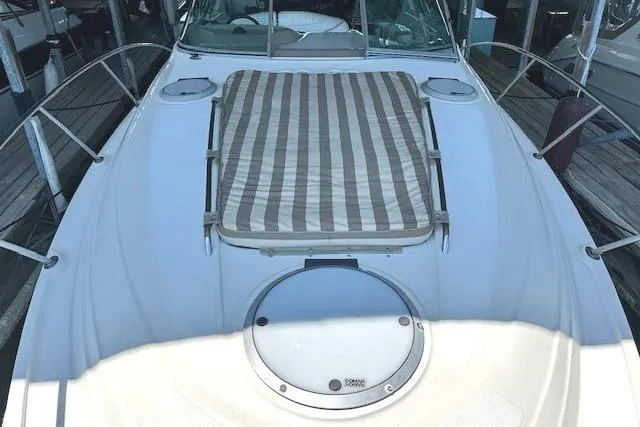 Slide: The Image of 2001 Maxum 3000 SCR boat deck with striped sun pad and hatch. - 17