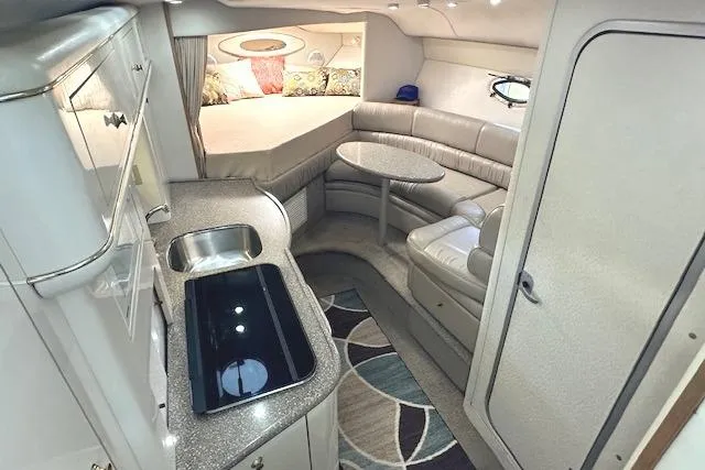 Slide: The Image of Luxurious interior of 2001 Maxum 3000 SCR yacht with kitchenette and cozy seating area. - 19
