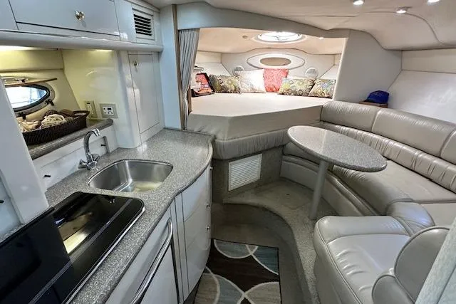 Slide: The Image of Interior of 2001 Maxum 3000 SCR yacht with kitchenette, seating, and bed. - 20