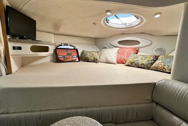 Slide: The Image of Interior of 2001 Maxum 3000 SCR boat with cozy bed, pillows, and porthole window. - 22