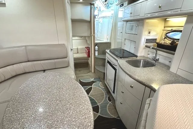 Slide: The Image of Interior of 2001 Maxum 3000 SCR yacht with kitchenette and seating area. - 24