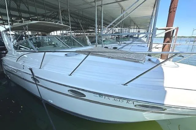 Slide: The Image of 2001 Maxum 3000 SCR boat docked under a covered marina. - 3