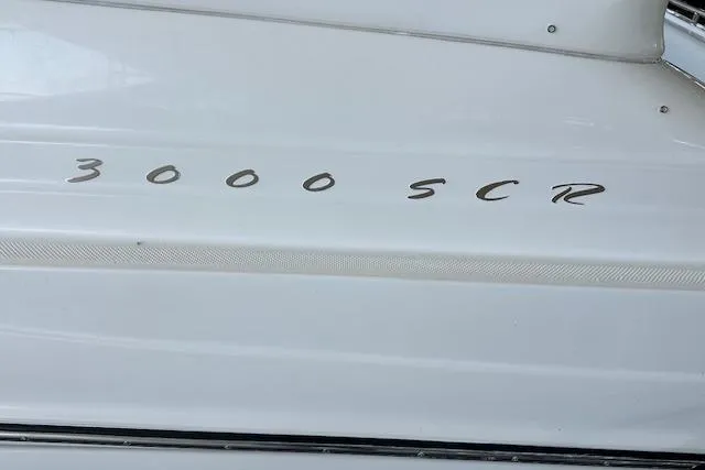 Slide: The Image of 2001 Maxum 3000 SCR boat model name on white hull. - 35