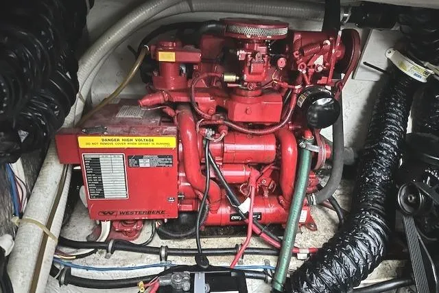 Slide: The Image of Engine compartment of a 2001 Maxum 3000 SCR boat featuring a red Westerbeke generator. - 36