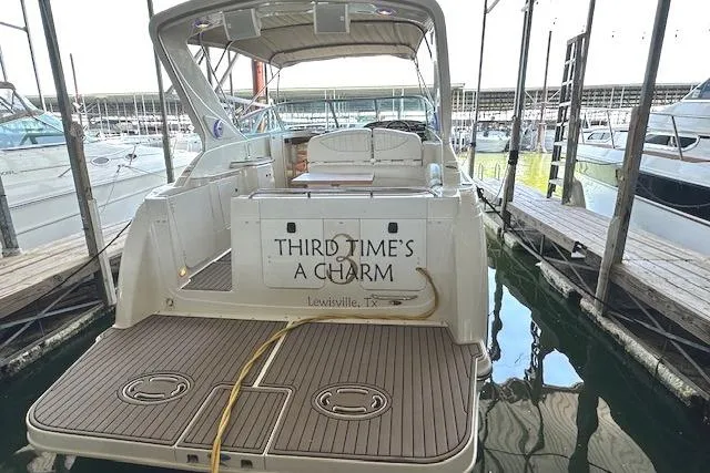 Slide: The Image of 2001 Maxum 3000 SCR boat docked, named "Third Time's a Charm," in Lewisville, TX marina. - 4