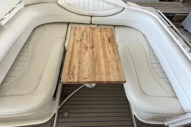 Slide: The Image of 2001 Maxum 3000 SCR boat interior with white seating and wooden table. - 9