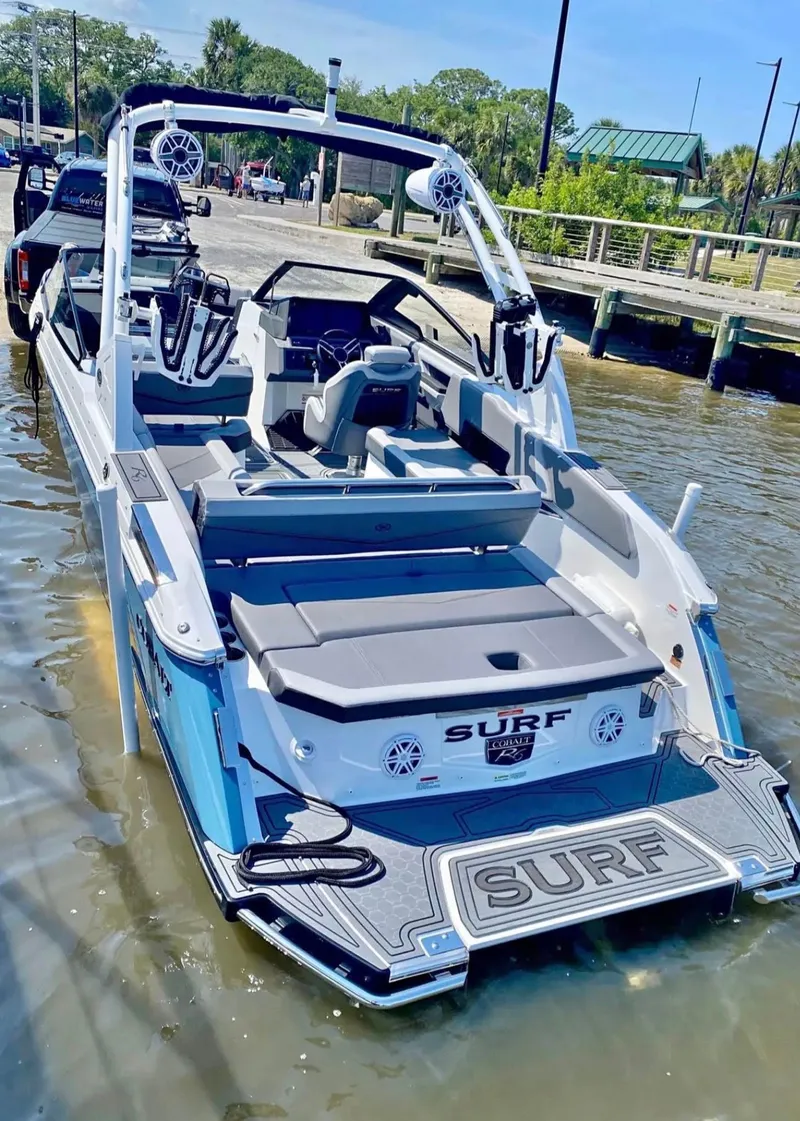 The Image of 2024 Cobalt R6SURF boat at dock, blue and white design. - 0