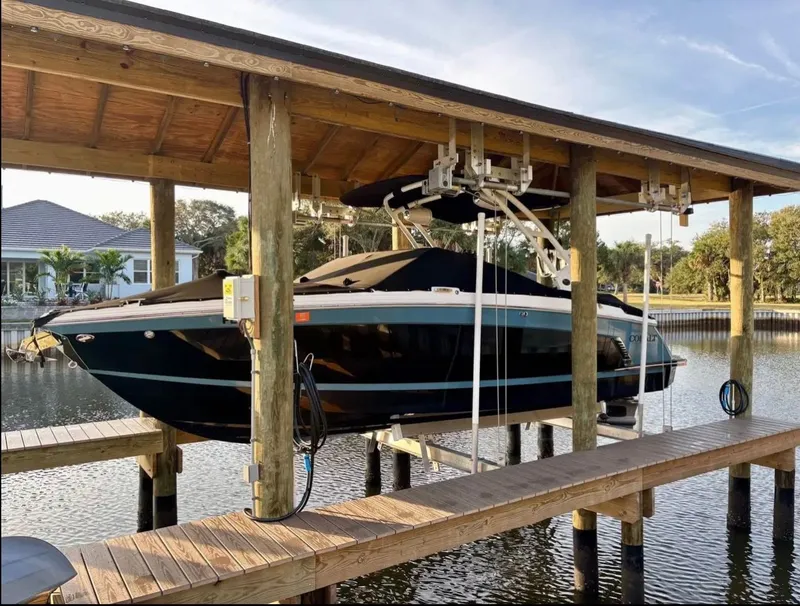 Slide: The Image of 2024 Cobalt R6SURF boat on a covered boat lift. - 3
