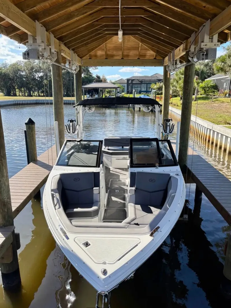 Slide: The Image of 2024 Cobalt R6SURF boat under a covered dock. - 4