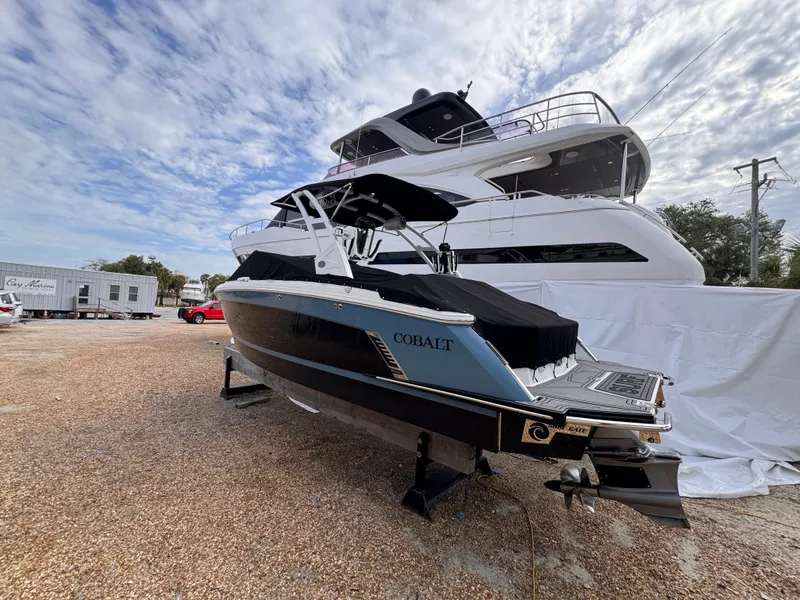 Slide: The Image of 2024 Cobalt R6SURF boat parked under a cloudy sky. - 6