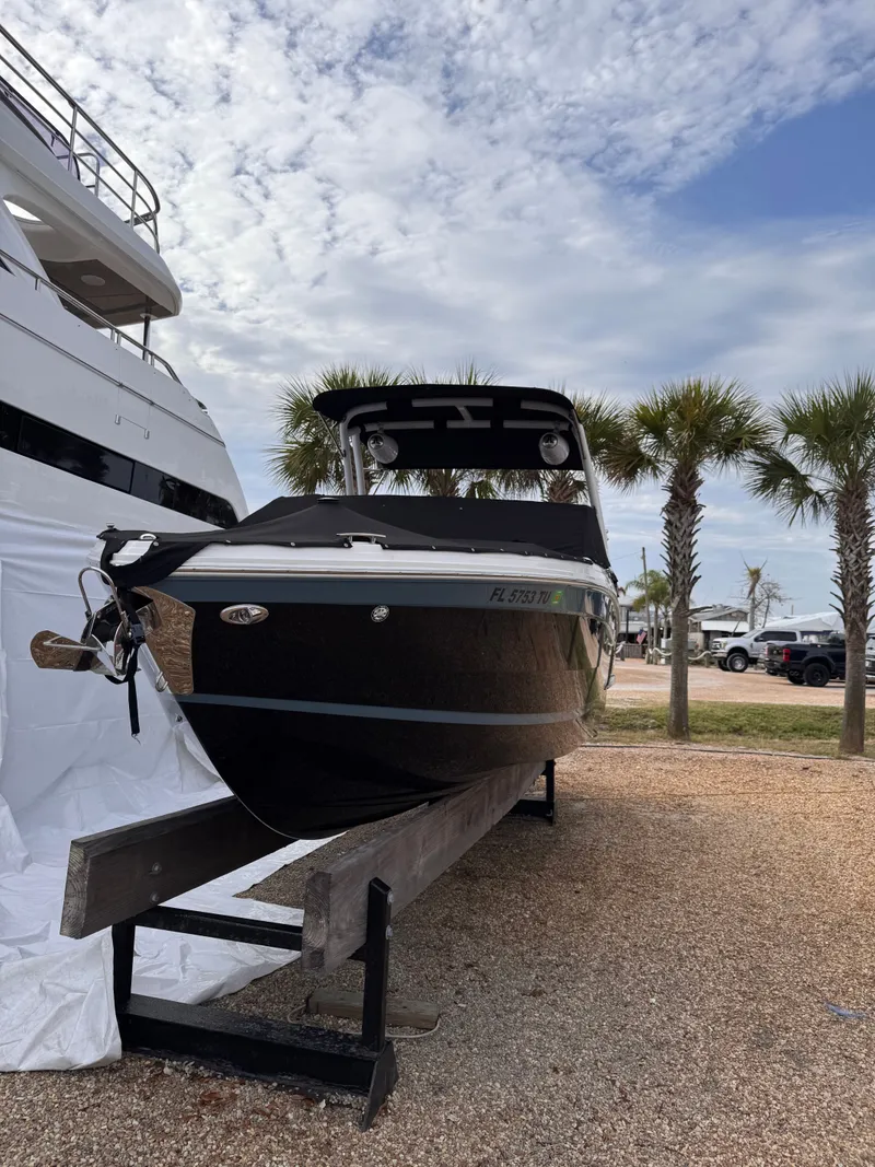 Slide: The Image of 2024 Cobalt R6SURF boat on a trailer, surrounded by palm trees. - 7