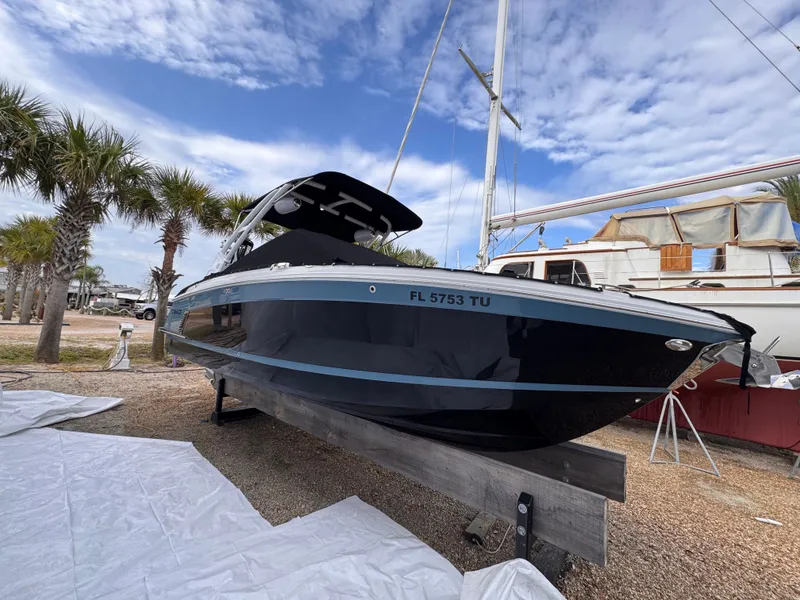 Slide: The Image of 2024 Cobalt R6SURF boat on dry dock, surrounded by palm trees. - 9
