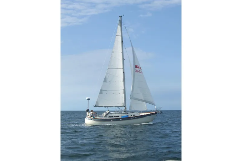 Slide: The Image of Sailing yacht Bruce Roberts 35, 1990 model, cruising on open sea under clear skies. - 71