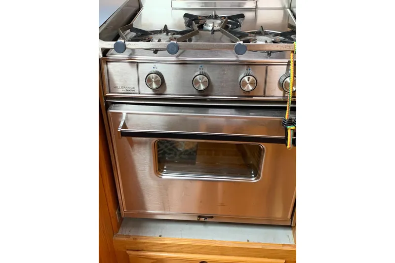 Slide: The Image of Stainless steel marine stove with oven, featuring four burners and control knobs. - 24