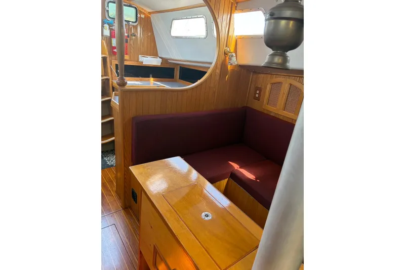 Slide: The Image of Interior of a 1990 Bruce Roberts 35 sailboat with wooden finish and cozy seating area. - 10