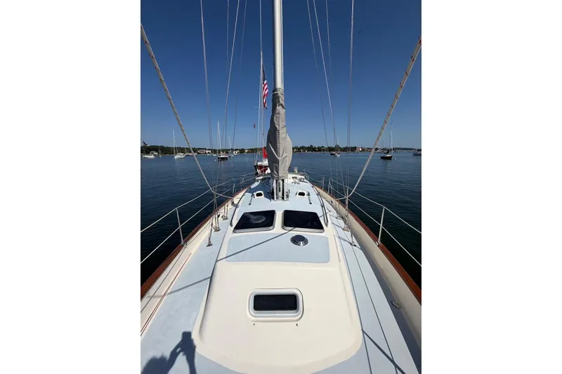 Slide: The Image of Sailboat deck view of 1990 Bruce Roberts 35, moored in calm waters. - 45