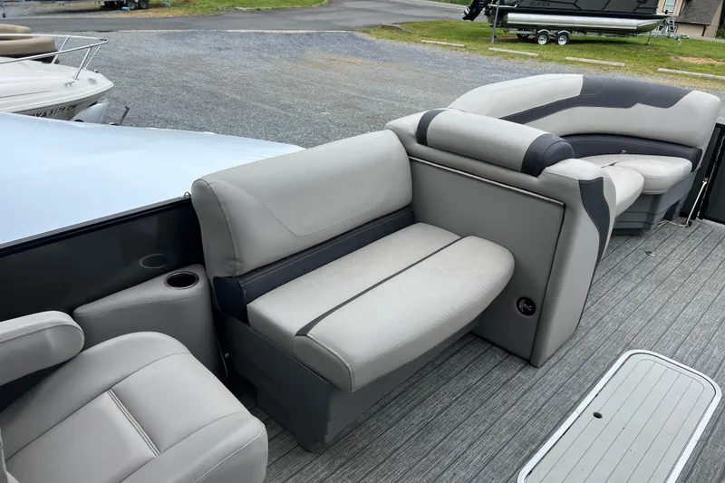 Slide: The Image of 2021 Sylvan L5 DLZ pontoon boat interior with gray seating and cup holders. - 11