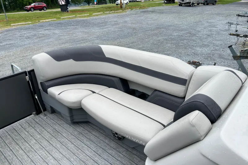 Slide: The Image of 2021 Sylvan L5 DLZ boat interior with gray and black seating on a dock. - 5